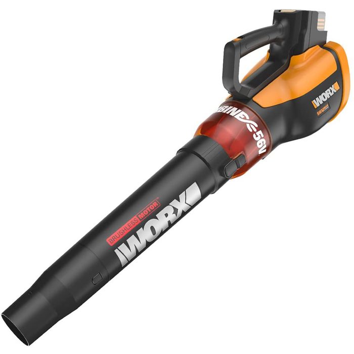 A cordless leaf blower is positioned horizontally, featuring a black and orange design, with a visible handle and nozzle, ready for clearing debris.