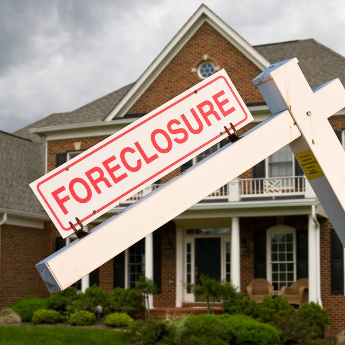 Foreclosure sign in front of a house