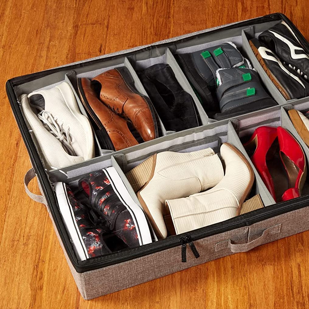 A divided storage container holds various types of shoes, organized neatly. The setting features a wooden floor, enhancing the container's fabric texture.