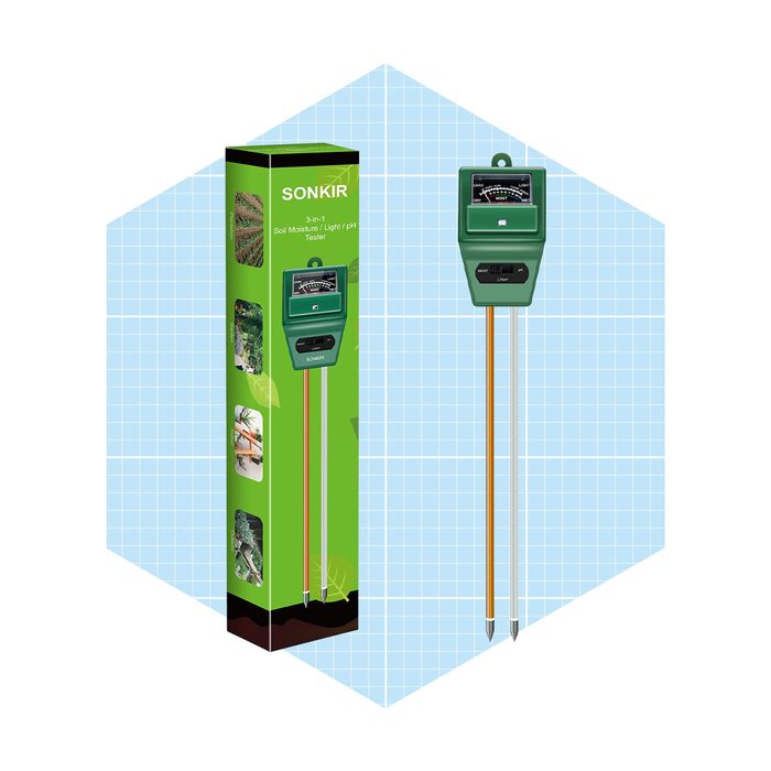 A green 3-in-1 moisture, light, and pH tester stands next to its packaging, set against a light blue grid background.
