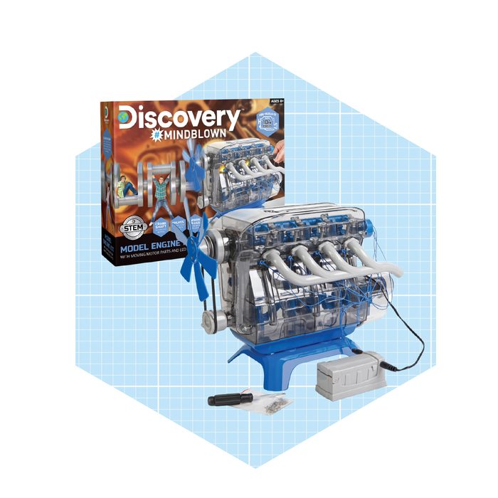 A clear model engine with visible moving parts is displayed next to a colorful box labeled