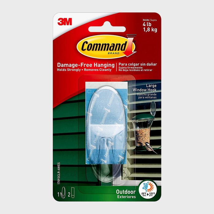 A packaged window hook is displayed, designed for damage-free hanging. It shows a hook and a feeding container, with directions and temperature guidelines.