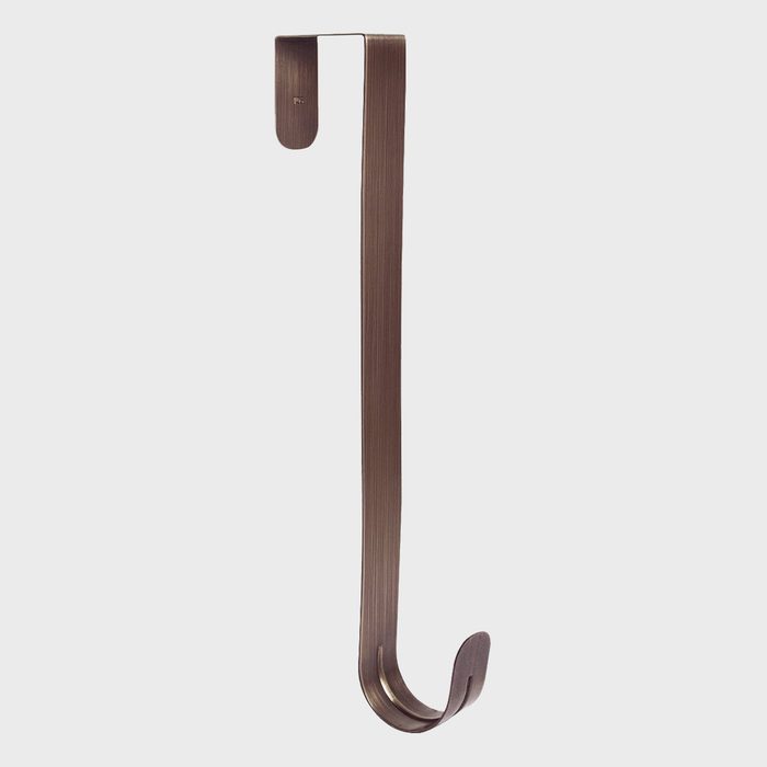 A metal hook hangs vertically, designed to hold items. The sleek, dark finish contrasts against a light background, emphasizing its minimalist style.
