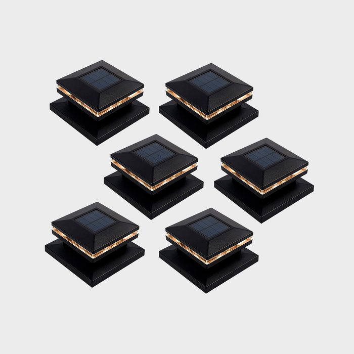 Six black solar-powered lights are arranged in two rows, each featuring a square base and a slanted top with a solar panel on it.