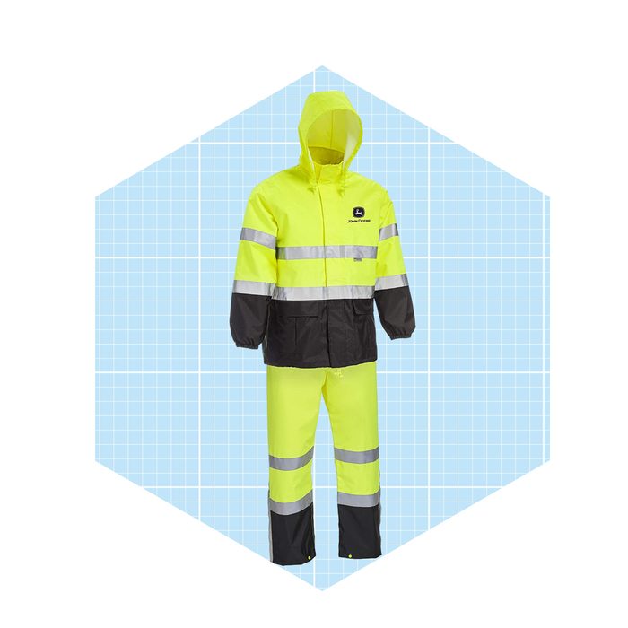 A bright yellow waterproof jacket and pants, featuring black accents and reflective stripes, are displayed on a blue grid background.
