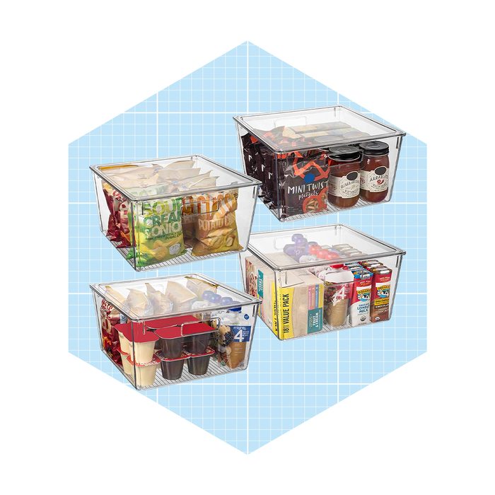 Four transparent bins contain assorted snacks and beverages, organized and displayed against a light blue grid background.