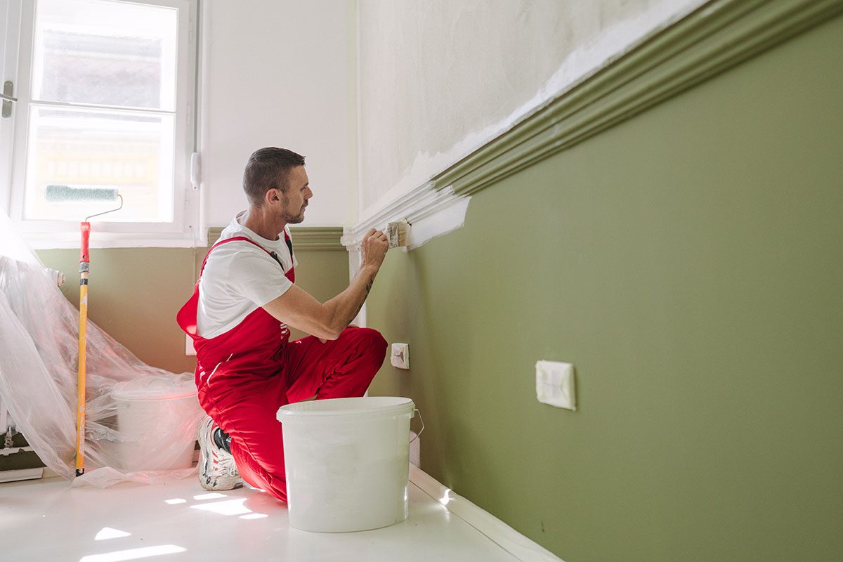 A professional house painter's painting an apartment